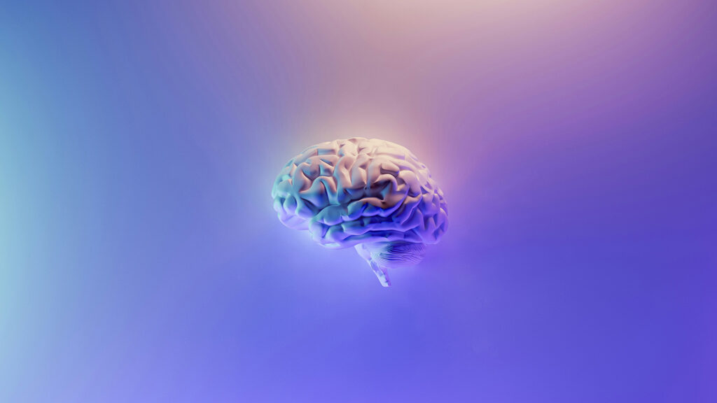 A colorful brain sits in the center of a colorful pastel gradient background.